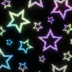 many different colored stars on a black background