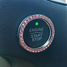 the engine start stop button is decorated with pink crystals