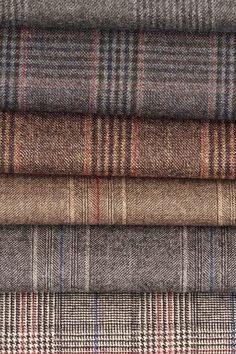 four different plaid fabrics stacked on top of each other in various colors and patterns,