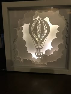 an intricate paper cut in the shape of a hot air balloon