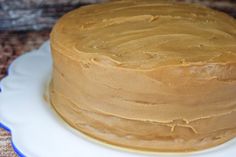 a frosted cake sitting on top of a white plate