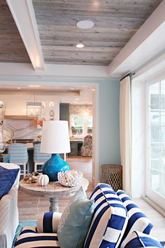 a living room with blue and white furniture