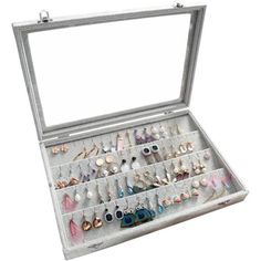 an open jewelry box filled with lots of different types of earrings and bracelets on display