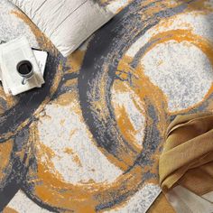 an orange and grey rug with circles on it, next to a cup of coffee