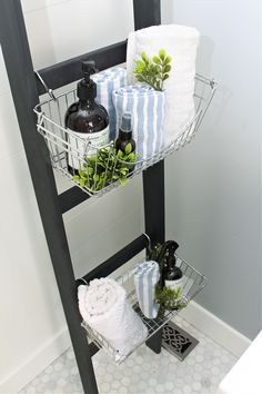 a bathroom shelf with towels, soaps and plants on it in front of the shower