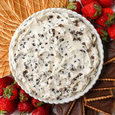 an ice cream dip surrounded by strawberries and crackers