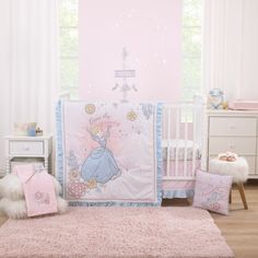 a pink and blue princess crib bedding set in a child's bedroom