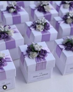 many purple and white gift boxes with flowers on them are arranged in the shape of cubes