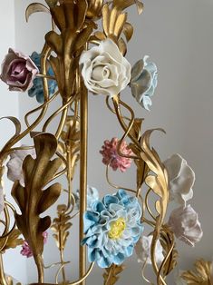 a gold chandelier with multi colored flowers on it