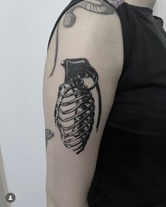 a man's arm with a skeleton tattoo on it and an owl in the ribcage