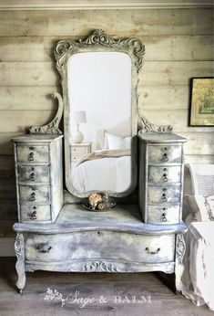 an antique dresser and mirror in a bedroom