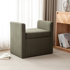 a green chair sitting next to a book shelf