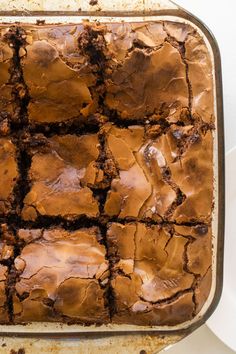 a pan filled with brownies sitting on top of a table