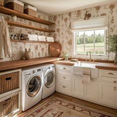 a washer and dryer in a small room with open shelves on the wall