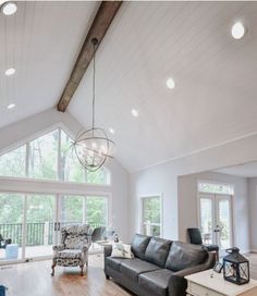 a living room filled with furniture and lots of windows