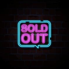 a neon sign that says sold out on a dark brick wall with the word sold out in