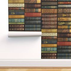 a stack of books on the wall next to a shelf