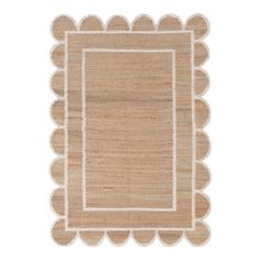 a beige rug with scalloped edges and a white border on the top of it