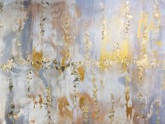 an abstract painting with gold and silver paint on it's surface, showing the texture of metallic foil