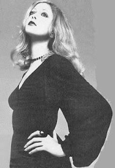 a black and white photo of a woman with her hands on her hips wearing a dress