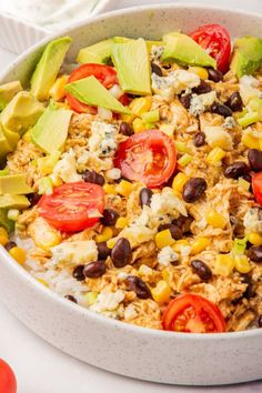 a white bowl filled with rice and vegetables