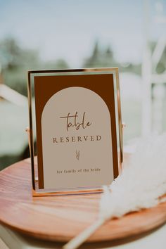 a table with a sign on it that says to be reserved for family of the bride