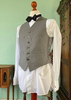 Up for sale is this very dandy looking dove gray 1950's waistcoat. This one would be excellent to combine with any formal daywear like morningcoats or stroller suits. Ideal for weddings or other formal events. The waistcoat is in excellent vintage condition! This waistcoat is approximately size 46 EU/36 US, but please refer to the measurements below for a more accurate idea of the fit. Measurements are taken with the item lying on a flat surface in cm: Shoulders30 Chest43,5 Waist41,5 Length57 (f Classic Gray Vest For Work, Classic Gray Formal Vest, Classic Tailored Gray Vest, Gray Sleeveless Vest For Formal Occasions, Classic Fitted Gray Vest, Elegant Tailored Gray Vest, Classic Tailored Wedding Vest, Classic Sleeveless Three-piece Suit For Wedding, Classic Fitted Nehru Jacket For Groom