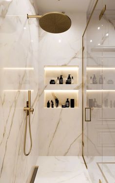 a bathroom with white marble walls and flooring, including a walk - in shower