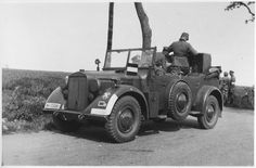 an old black and white photo of a man sitting in the back of a truck