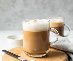 two glasses of coffee on a wooden board