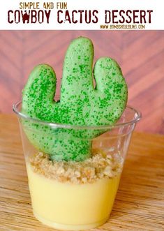 a small dessert with green frosting and a cactus shaped cookie