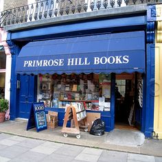 a blue store front with books on display