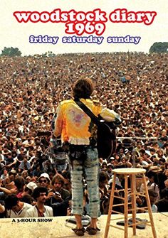 a person with a guitar standing in front of a crowd