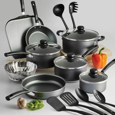 an assortment of pots and pans with various cooking utensils