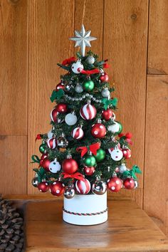 a small christmas tree with ornaments on it