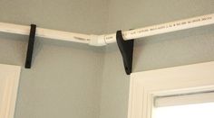 two black and white handles hang from the ceiling in front of a door with a light on it