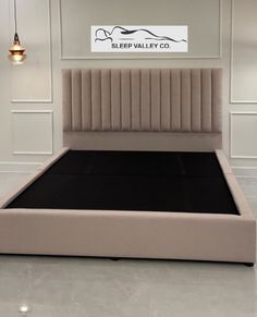 the bed is made up and ready to be used in this showroom or office