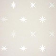 the wallpaper is white and has snowflakes on it, as well as stars