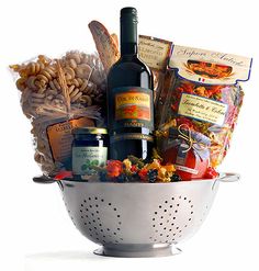 a white cola basket filled with wine and snacks