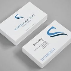 two white business cards with blue and black logo on the front one is for schutz & associates