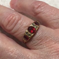 a close up of a person's hand with a ring on it