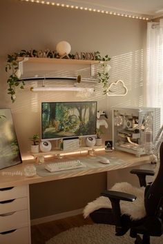 a desk with a computer on top of it in front of a window and some plants