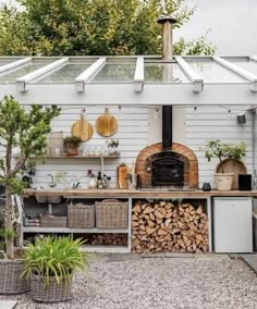 an outdoor kitchen with wood stacked on the counter