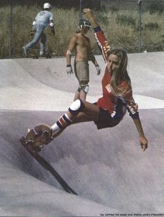 a man riding a skateboard up the side of a ramp at a skate park