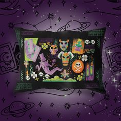 an image of a pillow with skulls and skeletons on it in the dark purple background