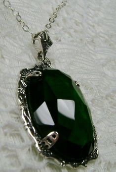 "Simulated Green Emerald Pendant Bubble Design#P10 Custom Made Inspired by Victorian era designs, I now offer this lovely Antique reproduction in sterling silver. The 22ct faceted simulated green emerald gemstone is 24mm long (15/16th\") and 18mm in width (3/4th\"). The entire pendant is 1.5\" long and 7/8\" wide. The chain (if chosen) is between 18-20 inches in length and is marked 925 as well. Notice the beautiful craftsmanship of the Victorian filigree setting. This pendant necklace is a true Emerald Necklace Aesthetic, Green Pendant, Silver Emerald Necklace With Intricate Design, Luxury Silver Emerald Necklace With Intricate Design, Victorian Green Pendant Jewelry, Green Amulet Necklace, Green Emerald Pendant Necklace In Sterling Silver, Green Gothic Necklace, Filigree Pendant Necklace