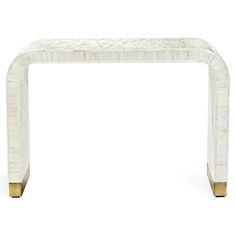 a white marble and brass console table with an intricate design on the top, against a white background