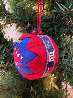 a red, white and blue ornament hanging from a christmas tree