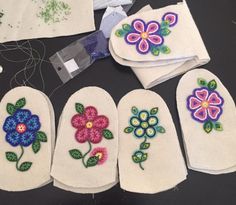 several embroidered flowers are sitting on the table