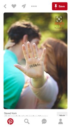 a man and woman are kissing with their hands in the air while one is holding his hand up